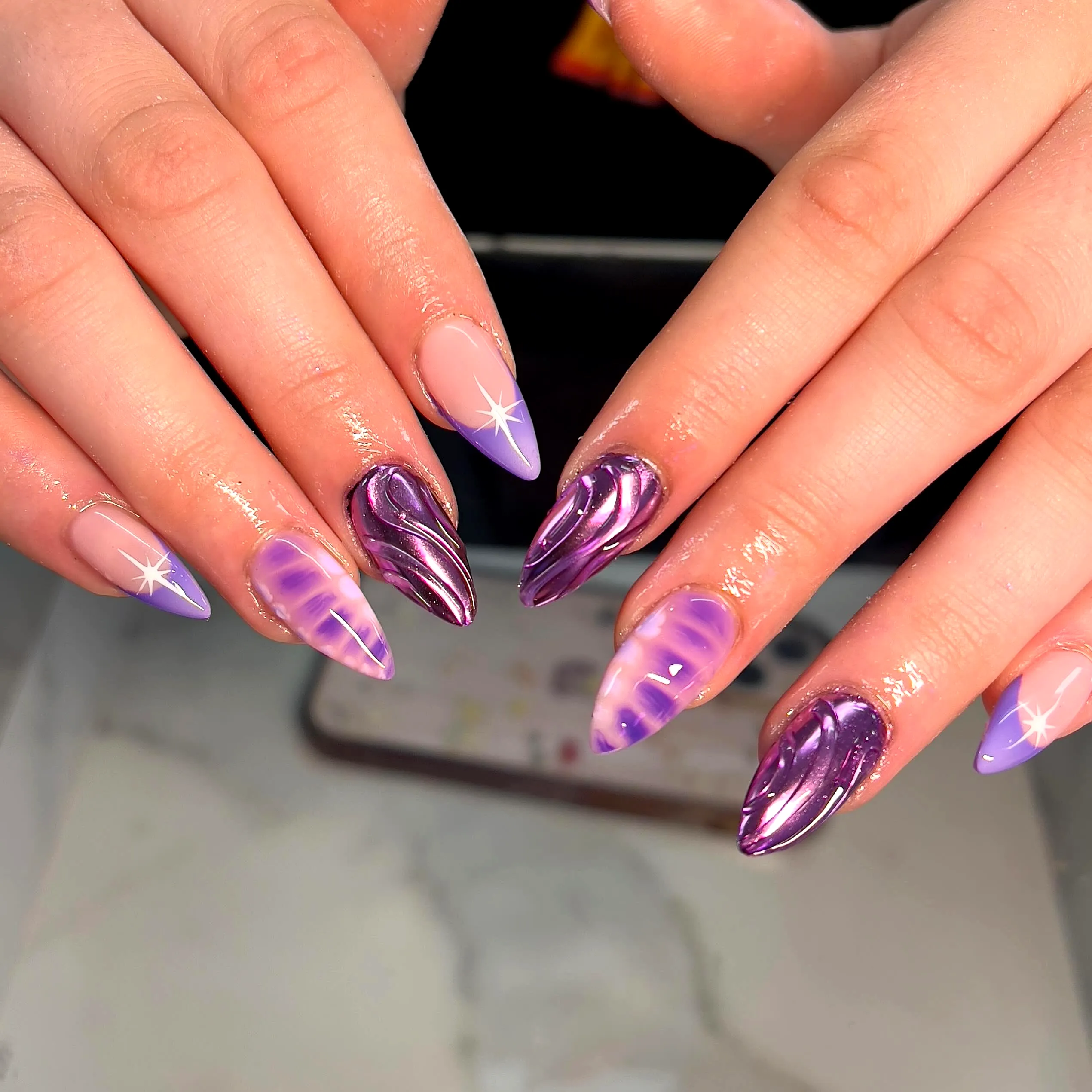 Stunning Almond Shaped Purple Nails with Gradient Swirls and Star Accents