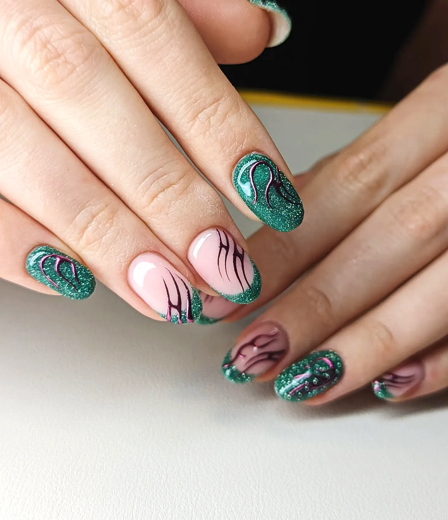 Stunning Almond Shaped Tribal Nails with Green Glitter and Elegant Black Lines