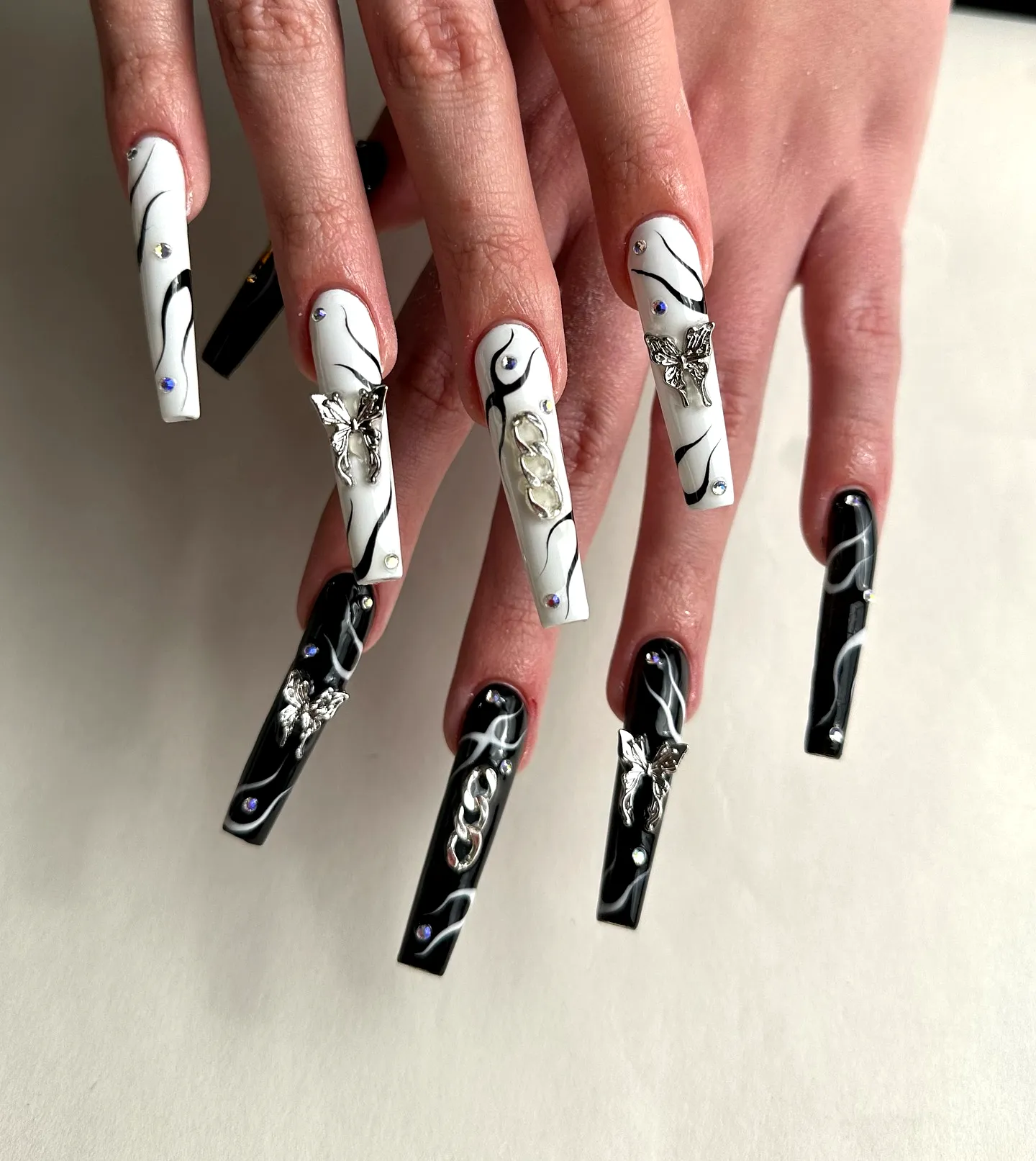 Stunning Coffin Tribal Nails in Black and White with Swirling Patterns and Glamorous Embellishments