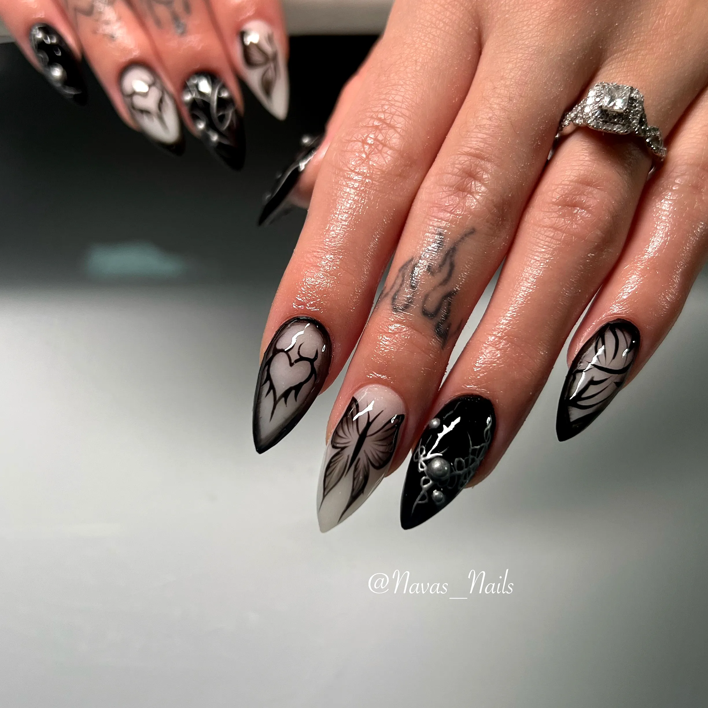 Stunning Stiletto Black Nails with Floral and Abstract Patterns in Monochromatic Style