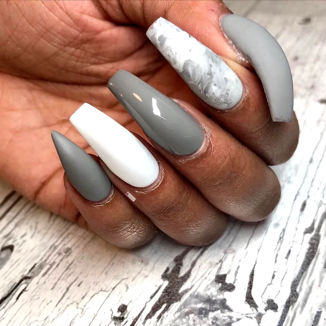Stylish Elongated Stiletto and Coffin Gray Nails with Marbled Patterns and Modern Art Elements
