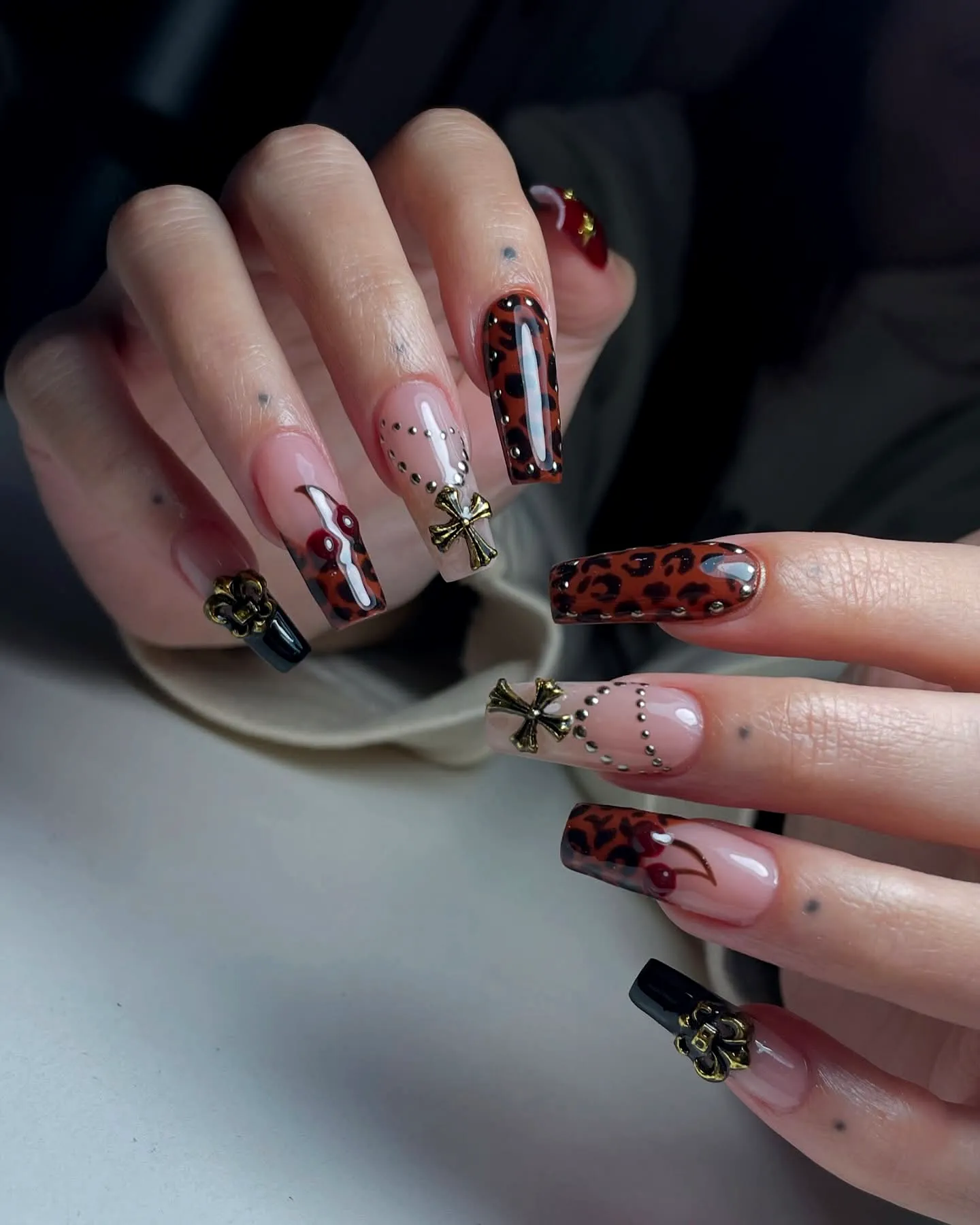 Stylish Long Coffin-Shaped Animal Print Nails with Leopard Pattern and Elegant Black Accents