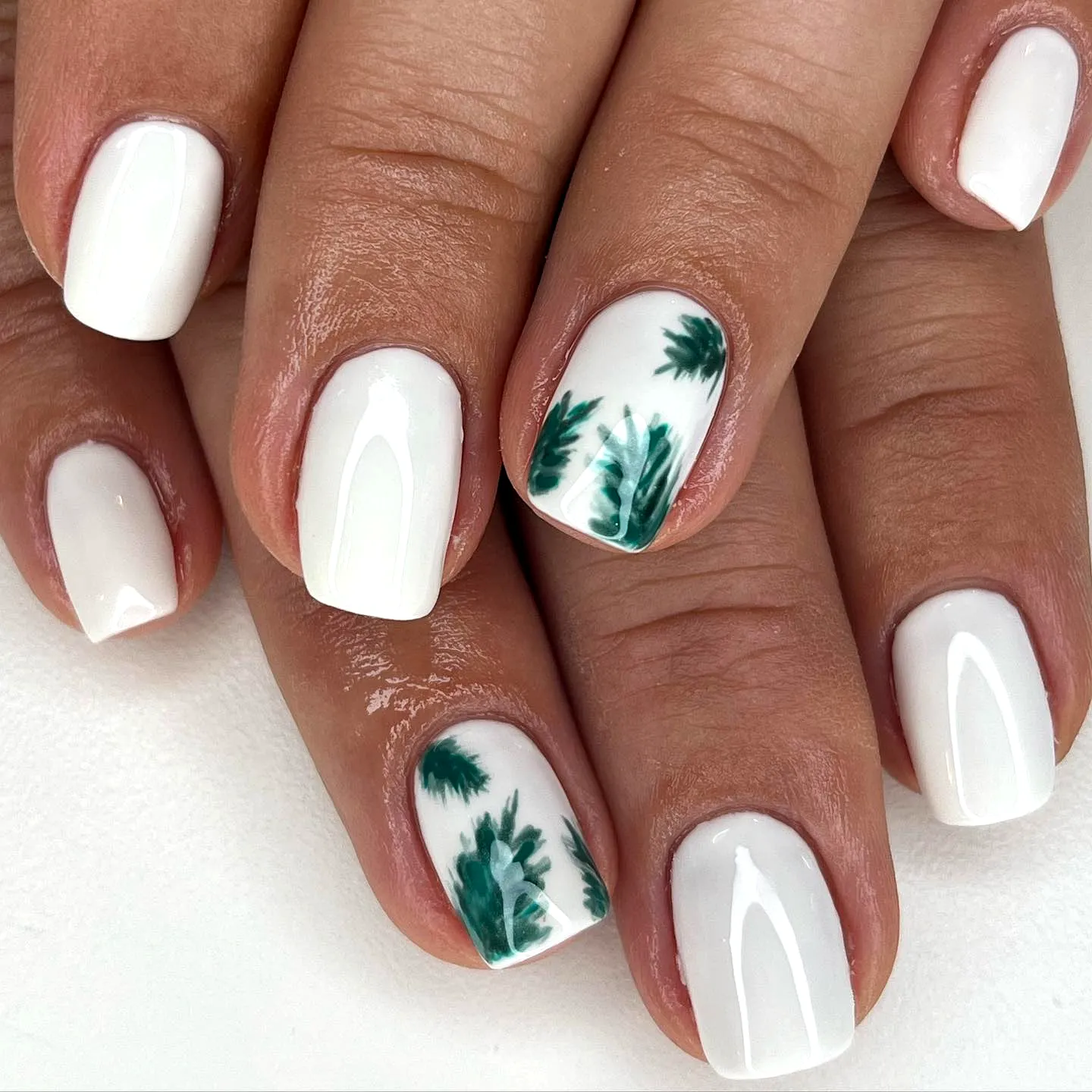 Stylish square white leaf nail designs with intricate green palm patterns for a fresh tropical vibe