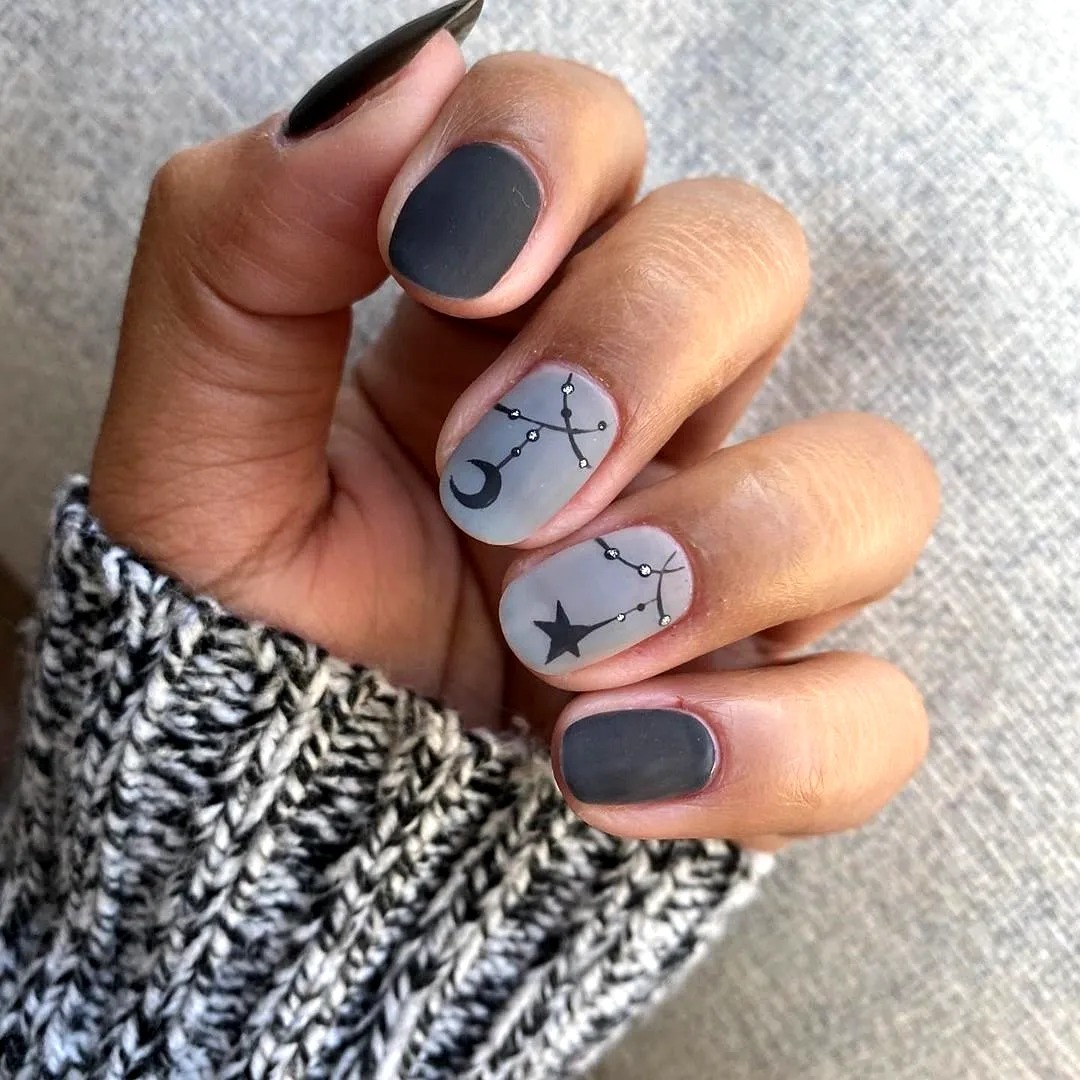 Trendy Stiletto Gray Nails with Celestial Motifs for a Chic Look