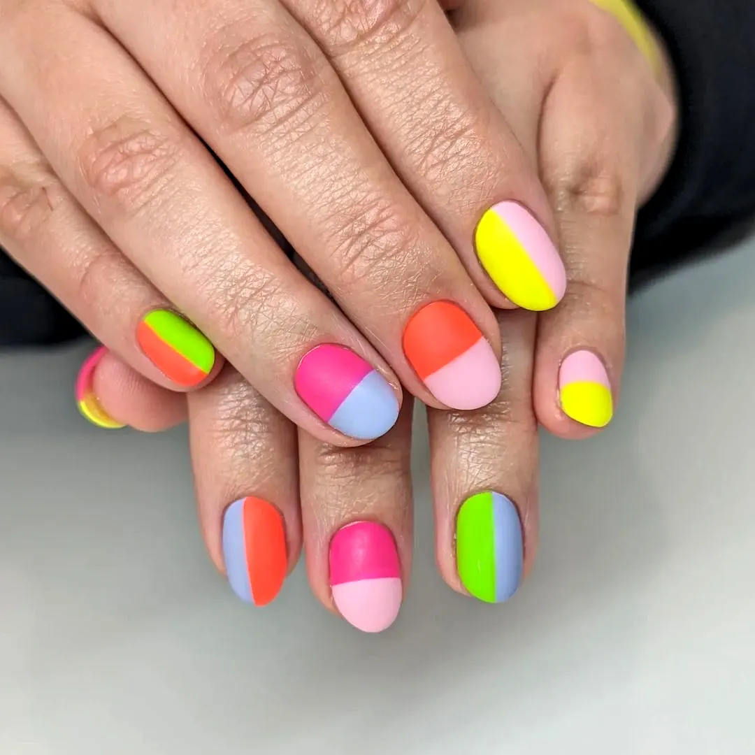 Vibrant Almond Shaped Color Block Nails with Bold Geometric Patterns in Matte and Glossy Finishes