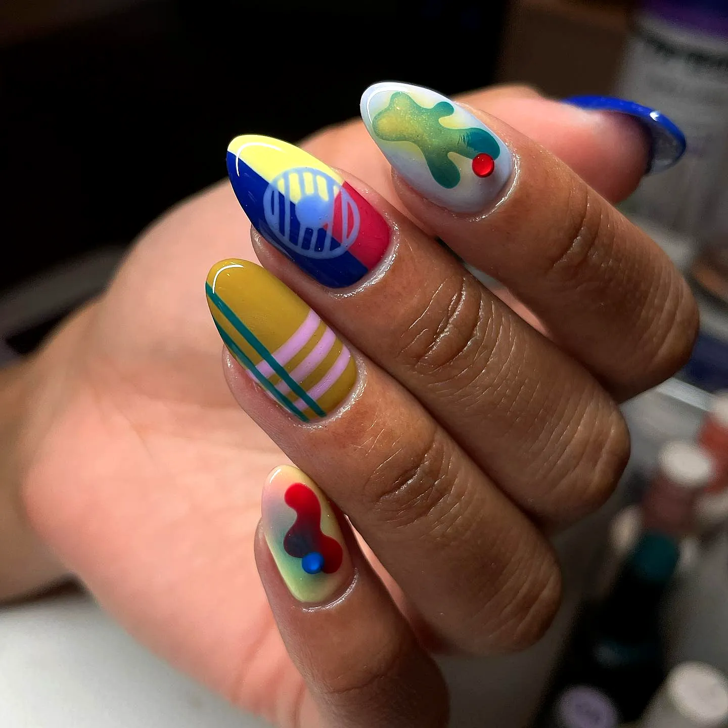 Vibrant Almond-Shaped Color Block Nails with Geometric Designs and Playful Patterns
