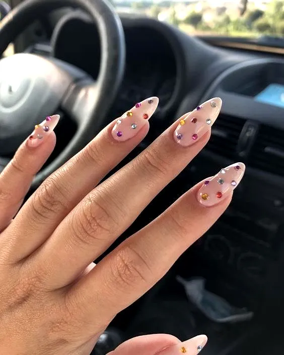 Vibrant Almond Shaped Rhinestone Nail Designs with Sheer Nude Base and Colorful Accents