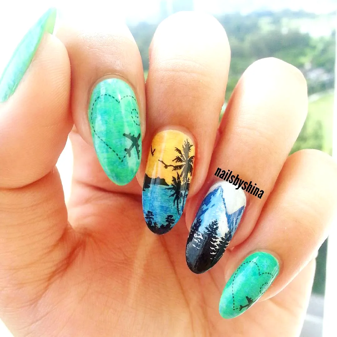 Vibrant Almond-Shaped Travel-Inspired Nails Featuring Mountains Palm Trees and Airplane Design
