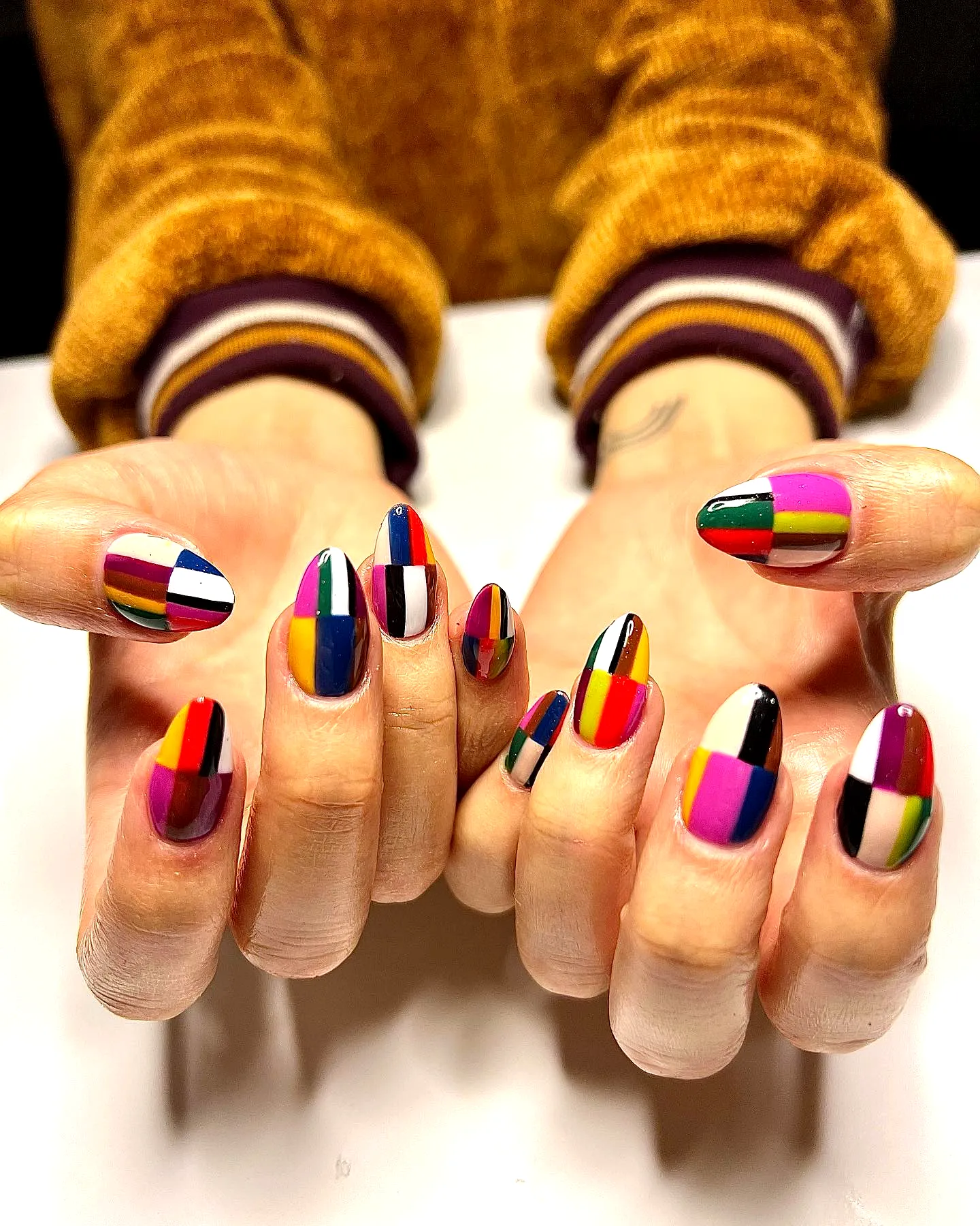 Vibrant Color Block Nails with Playful Geometric Patterns on Almond-Shaped Nails