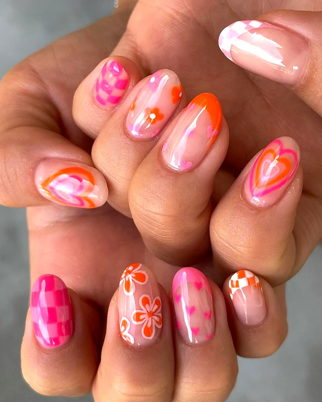 Vibrant Cute Summer Nail Designs in Natural Oval Shape Featuring Floral Patterns Hearts and Checkered Styles