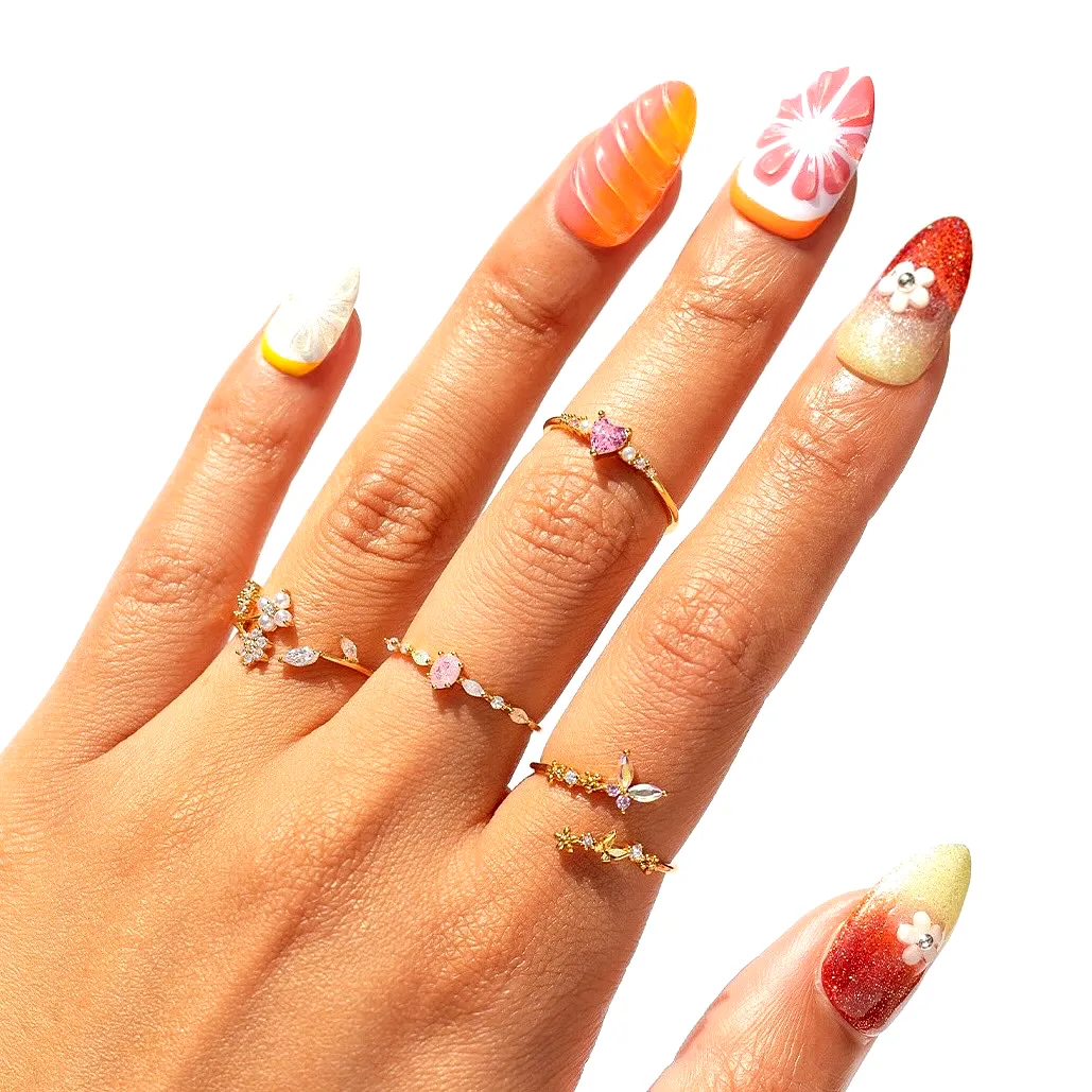 Vibrant Cute Summer Nail Designs with Pointed and Oval Shapes Featuring Floral Patterns and Glitter Accents