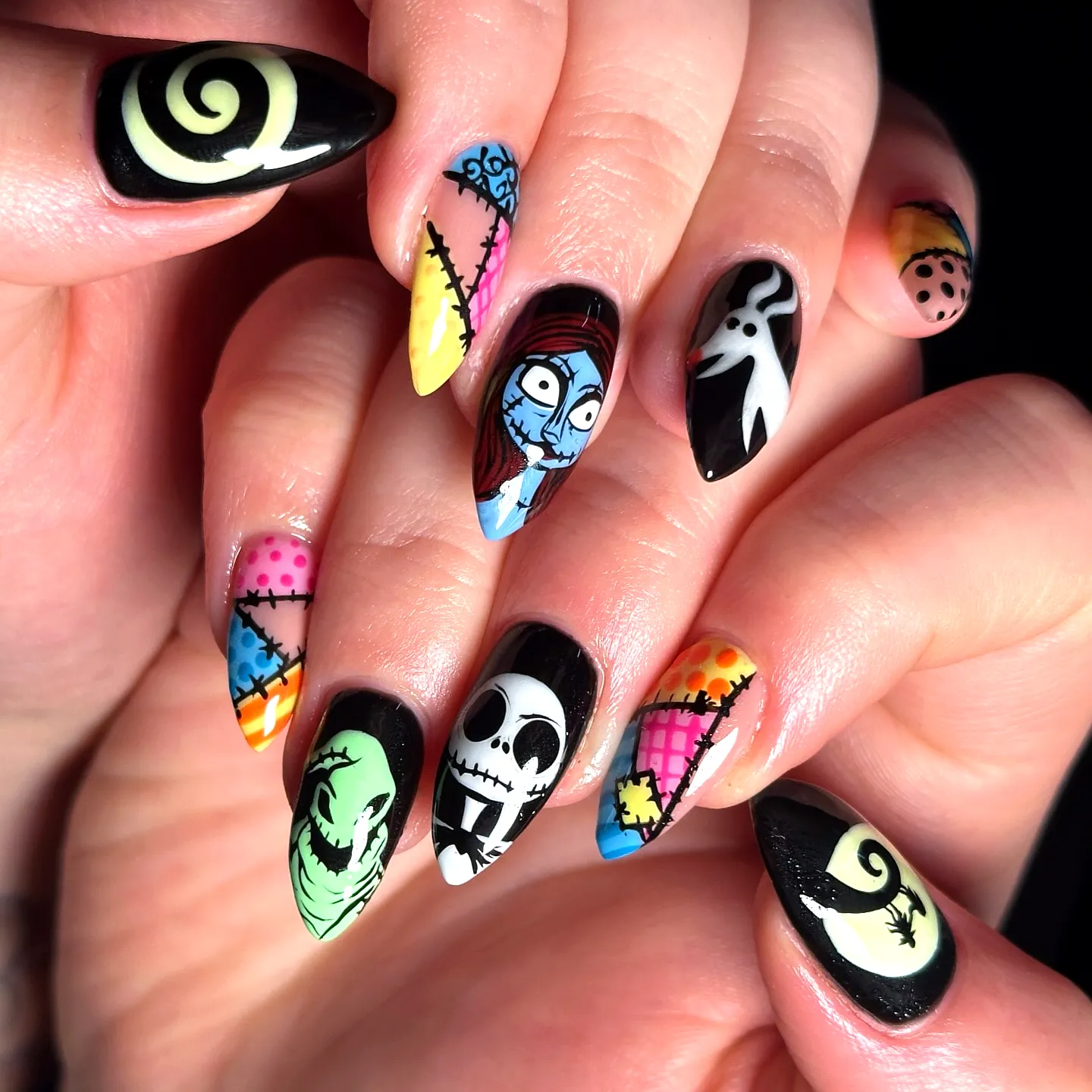 Vibrant Gothic Nightmare Before Christmas Nails with Pointed Tips and Whimsical Character Designs