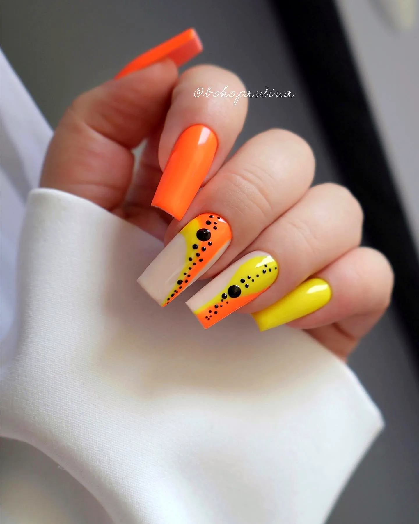 Vibrant Orange Nails in Long Square Shape with Playful Abstract Patterns