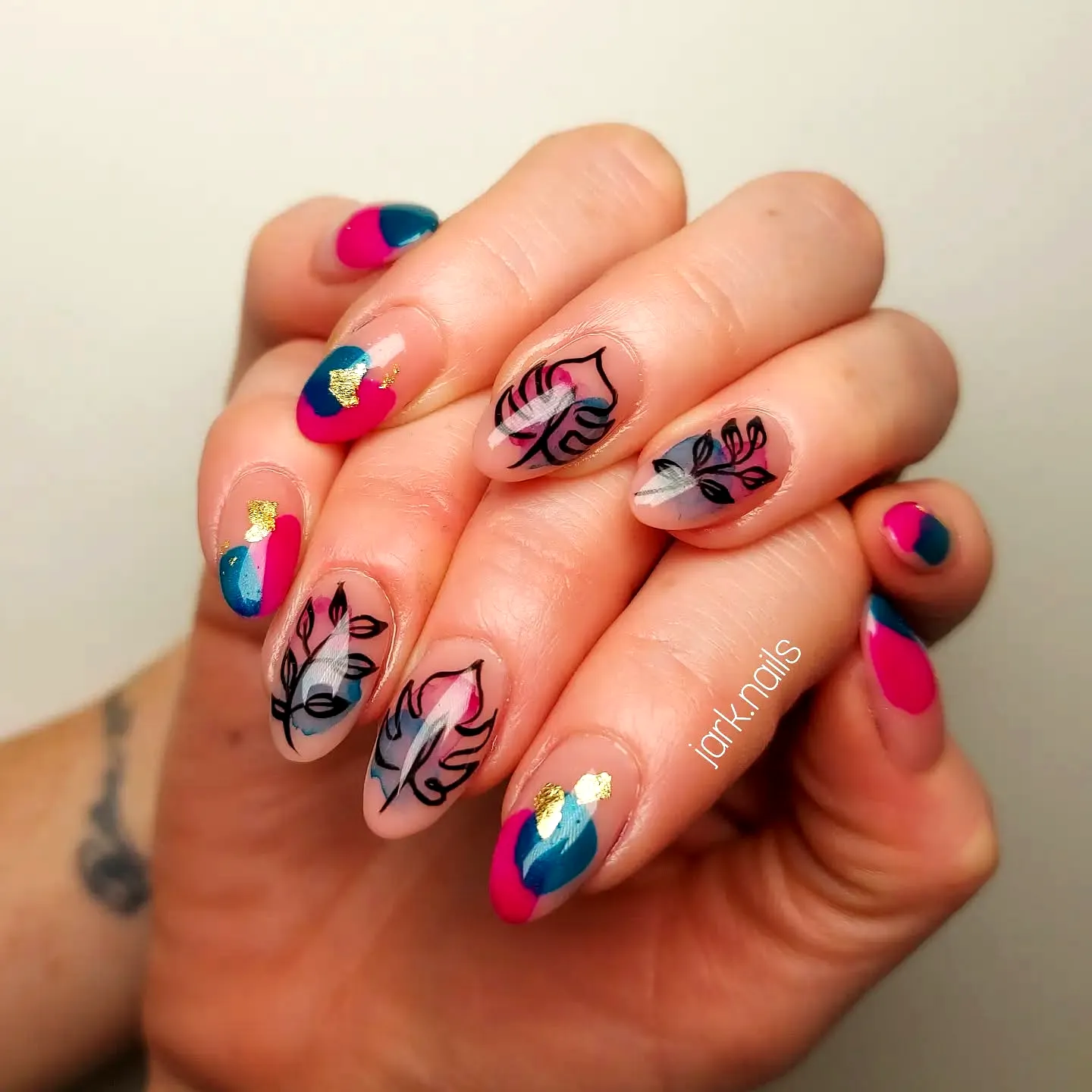 Vibrant Playful Leaf Nail Designs on Almond Shaped Nails with Bold Color Blocking and Delicate Line Art