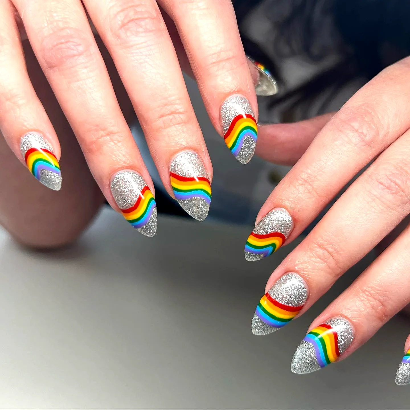 Vibrant Playful Pride Nails with Pointed Acrylic Shape and Glittery Silver Base