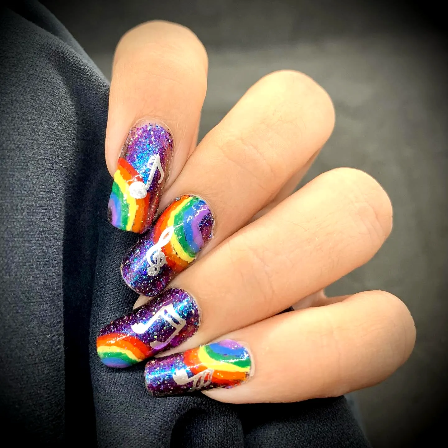 Vibrant Rainbow Nail Designs with Glitter and Musical Notes on Long Square-Shaped Nails