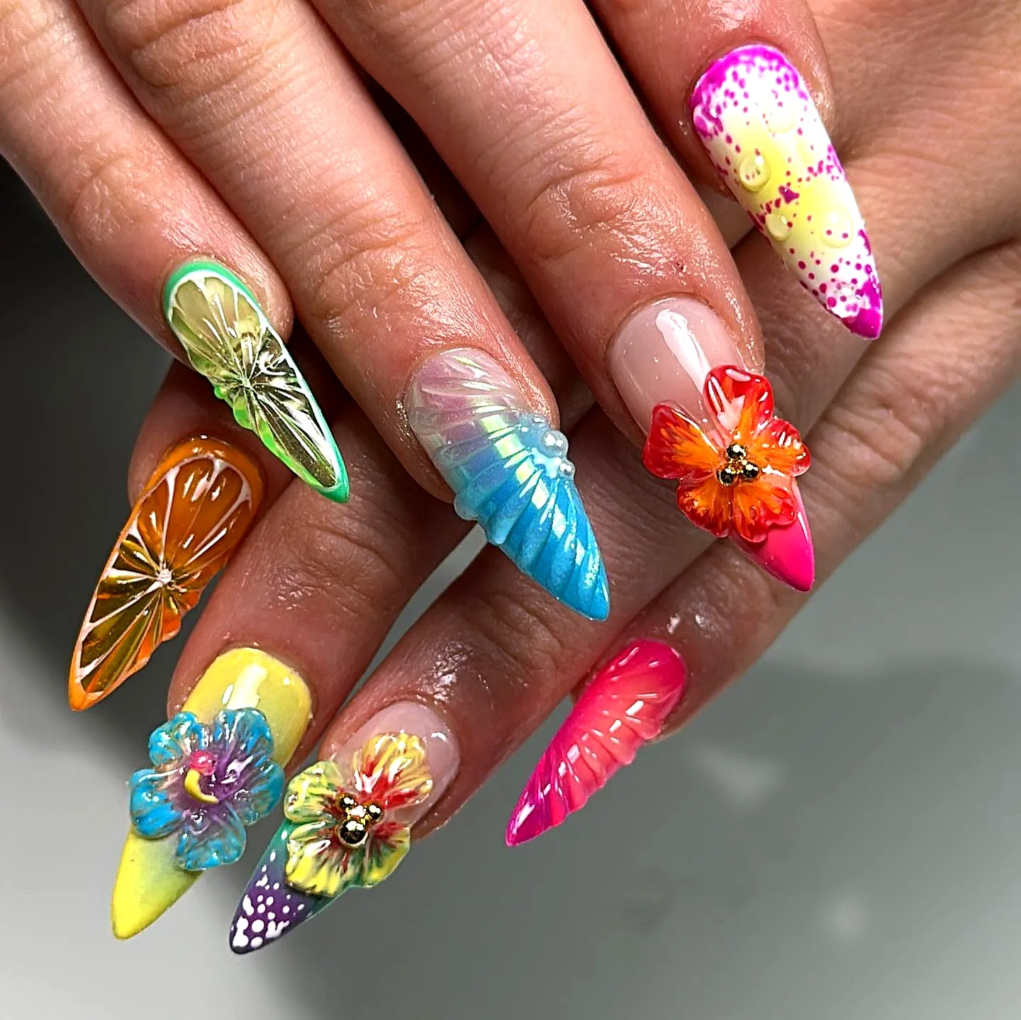 Vibrant Stiletto Tropical Nail Designs with 3D Floral Accents and Fruity Patterns