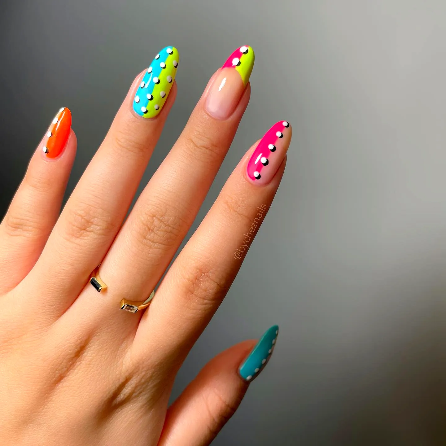 Vibrant Summer Nail Designs with Long Almond-Shaped Nails Featuring Playful Polka Dots and a Glossy Finish