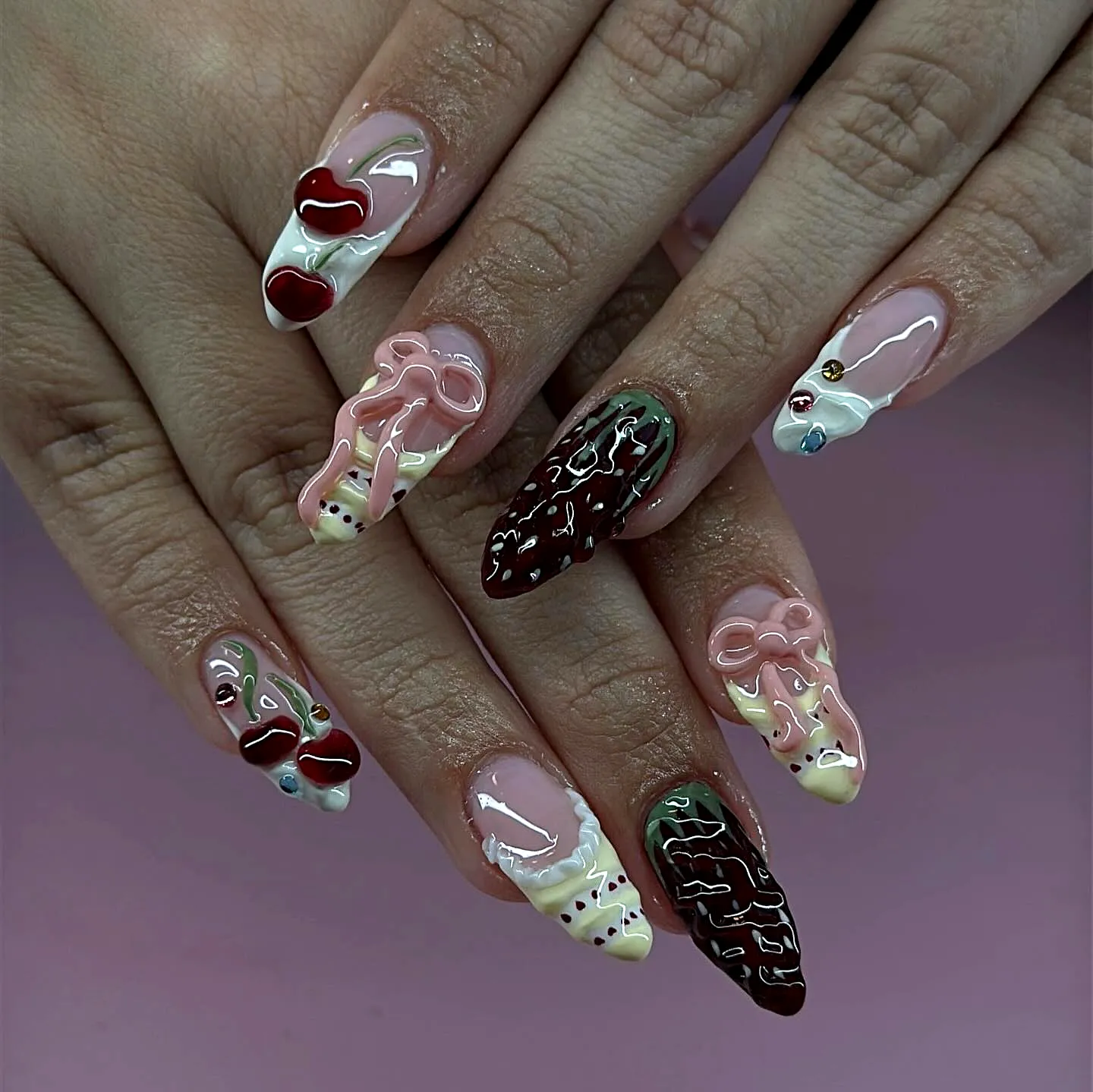 Whimsical Birthday Cake Nails with Almond-Shaped Design in Pink and Brown Featuring Hearts Drips and Bows