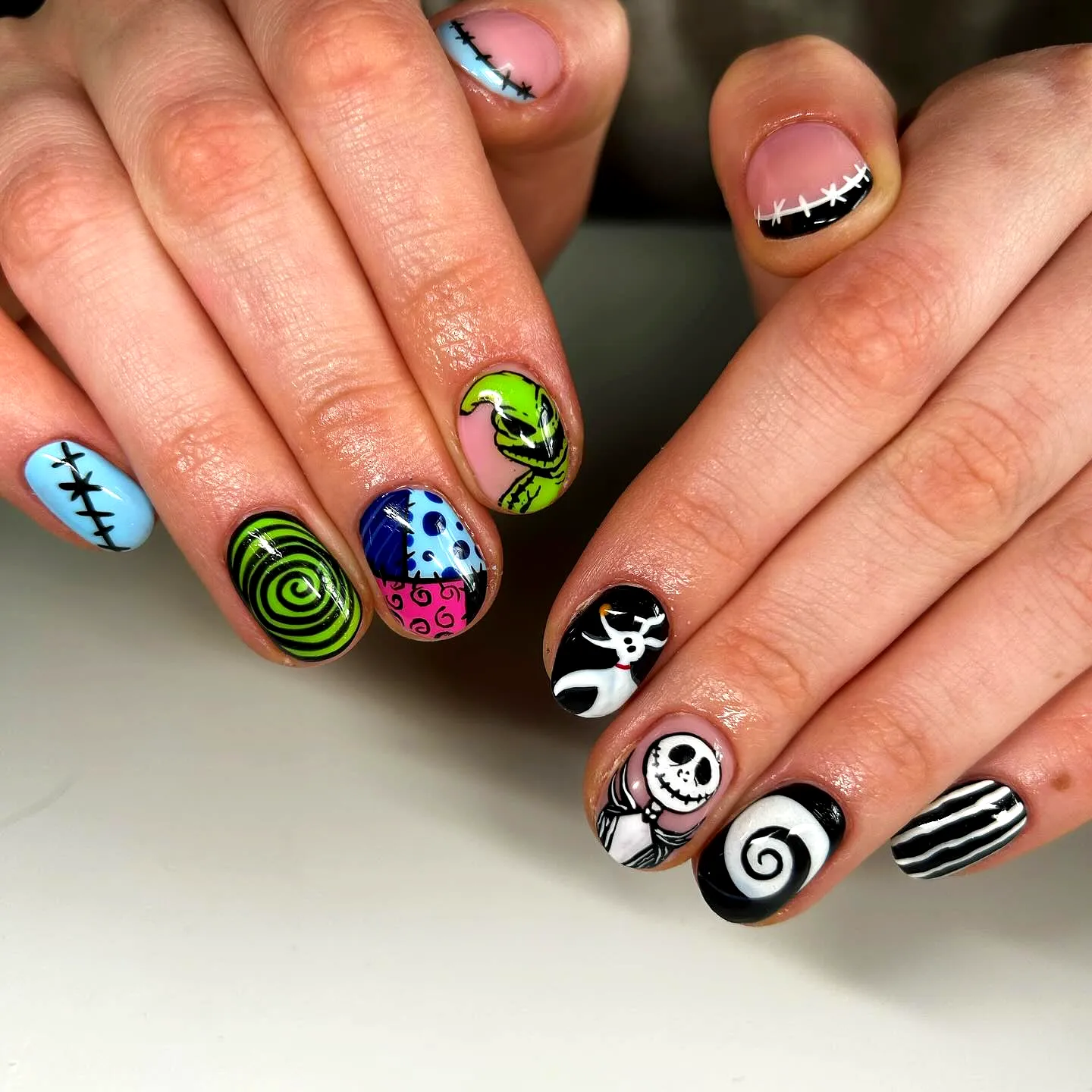 Whimsical Oval Nightmare Before Christmas Nails with Vibrant Colors and Playful Skull Art